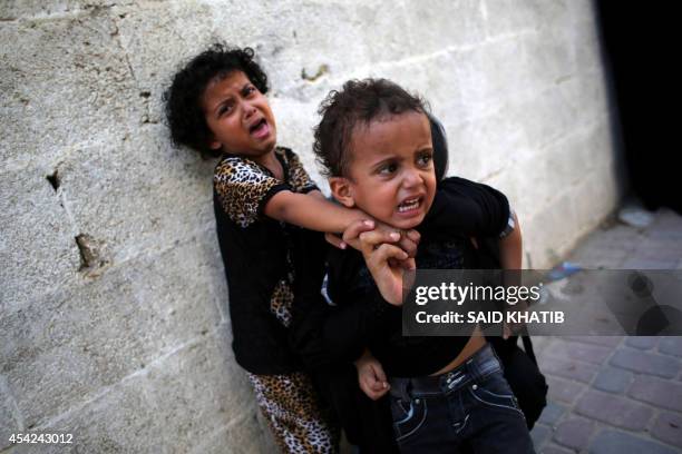 Children mourn during the funeral of two brothers 16-year-old Omar and 12-year-old Mohammed Breem, who were killed by an Israeli airstrike yesterday...