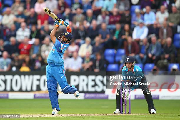 Suresh Raina of India hits a straight six off the bowling of James Tredwell as wicketkeeper Jos Buttler looks on during the second Royal London...