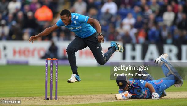 England bowler Chris Jordan attempts to run out India batsman MS Dhoni during the 2nd Royal London One Day International match between England and...