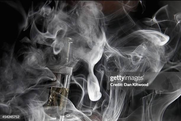 In this photo illustration, a man smokes an E-Cigarette at the V-Revolution E-Cigarett shop in Covent Garden on August 27, 2014 in London, England....