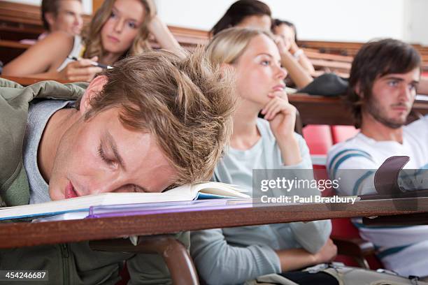 students in a classroom with one sleeping - boring presentation stock pictures, royalty-free photos & images