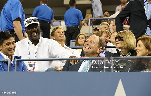 Michael Jordan chats with Tony Godsick and Anna Wintour during Roger Federer's match on Day 2 of the 2014 US Open at USTA Billie Jean King National...