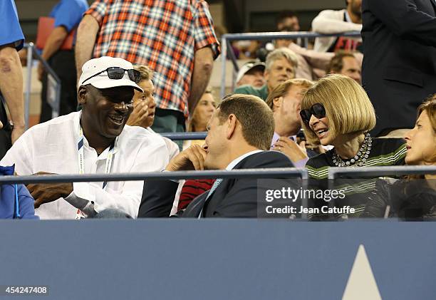 Michael Jordan chats with Tony Godsick and Anna Wintour during Roger Federer's match on Day 2 of the 2014 US Open at USTA Billie Jean King National...