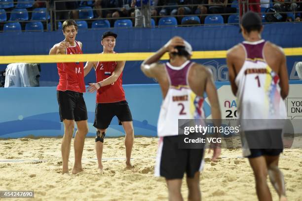 Oleg Stoyanovskiy and Artem Larzutkin of Russia celebrate after beating Jose Gregorio Gomez and Rolando Hernandez of Venezuela in the Men's Beach...