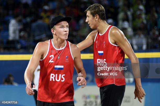 Oleg Stoyanovskiy and Artem Larzutkin of Russia compete with Jose Gregorio Gomez and Rolando Hernandez of Venezuela in the Men's Beach Volleyball...