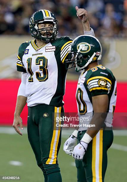 Quarterback Mike Reilly of the Edmonton Eskimos instructs receivers while playing against the Winnipeg Blue Bombers during a CFL football game at...