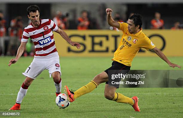 Labinot Haliti of Western Sydney Wanderers in action with Feng Xiaoting of Guangzhou Evergrande during the Asian Champions League Quarter Final match...