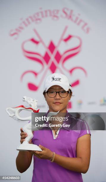 Lydia Ko of New Zealand with the winning score of Eleven under par holds up her the 2013 Swinging Skirts World Ladies Masters trophy, during the last...