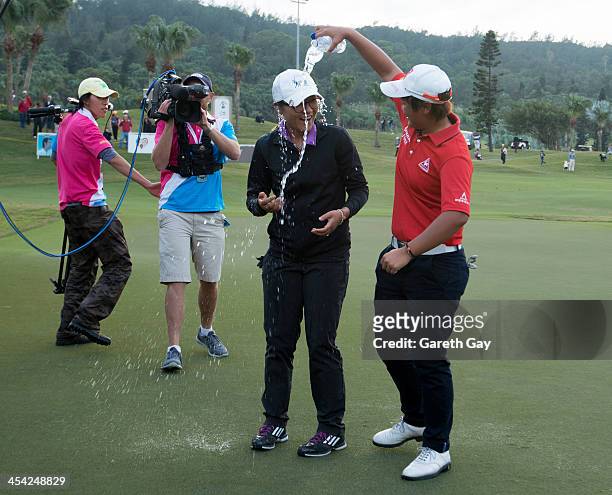 Lydia Ko of New Zealand, with the winning score of Eleven under par, is sprayed with water by Pei-Yun Chien of Taiwan, during the last day of the...