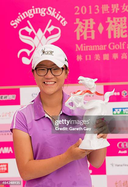 Winner of the 2013 Swinging Skirts World Ladies Masters, Lydia Ko of New Zealand, holds up her trophy for the cameras during the last day of the...