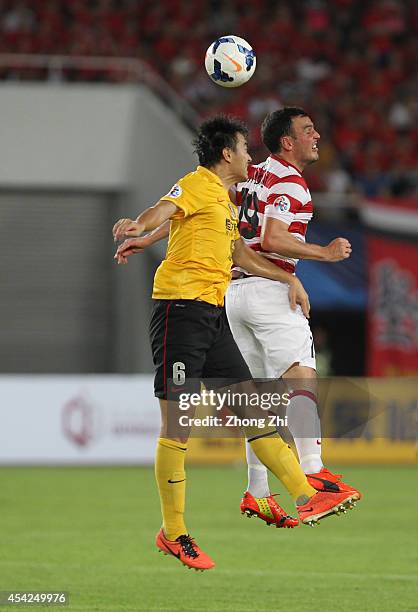 Mark Bridge of Western Sydney in action with Feng Xiaoting of Guangzhou Evergrande during the Asian Champions League Quarter Final match between the...