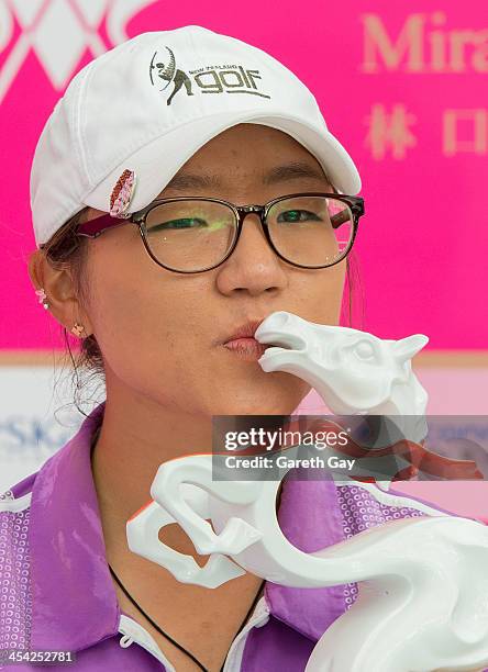 Lydia Ko of New Zealand, with the winning score of Eleven under par, kisses her trophy, during the last day of the Swinging Skirts 2013 World Ladies...