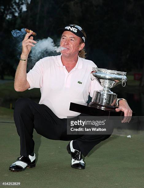 Miguel Angel Jimenez of Spain celebrates with the trophy after winning the final round of the 2013 Hong Kong open at The Hong Kong Golf Club on...