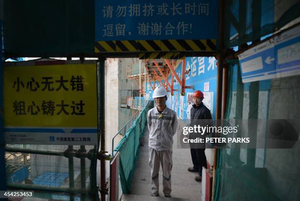 Workers wait for French Prime Minister Jean-Marc Ayrault to arrive at the joint Sino-French Taishan Nuclear Power Station outside the city of Taishan...