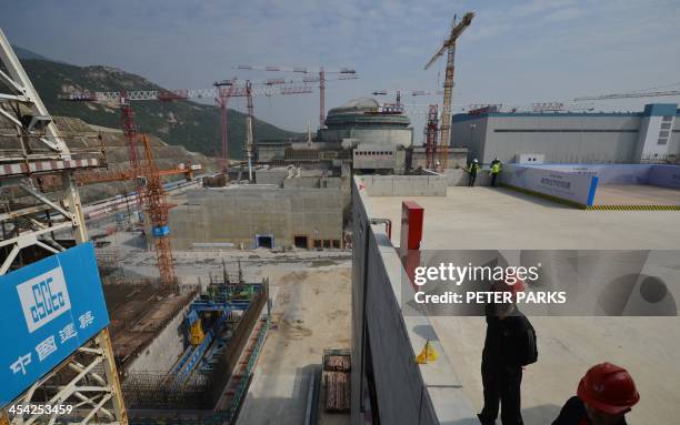 Workers wait for French Prime Minister Jean-Marc Ayrault to arrive at the joint Sino-French Taishan Nuclear Power Station outside the city of Taishan...