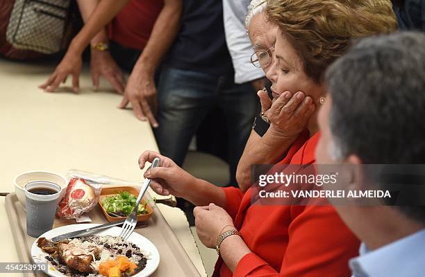 Presidential candidate for the Brazilian Workers' Party and current Brazilian President Dilma Rousseff , is greeted by a supporter whilst having...