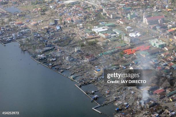 An aerial image taken on board a Japanese C-130 cargo plain shows Tacloban coastal villages on December 8, 2013 in the aftermath of Super Typhoon...