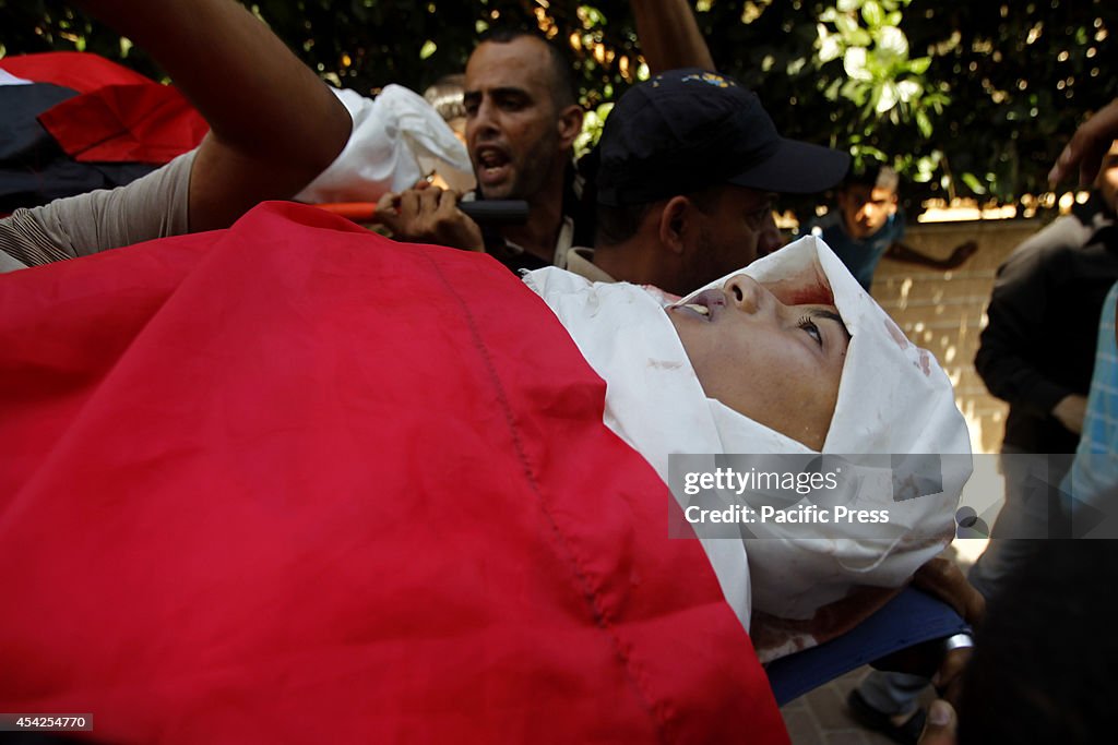 Palestinian carry the body of Mohammed Braim ,12, who was...