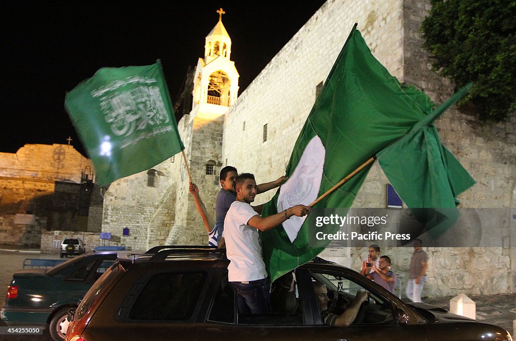 Palestinians celebrate the newly agreed cease-fire  between...