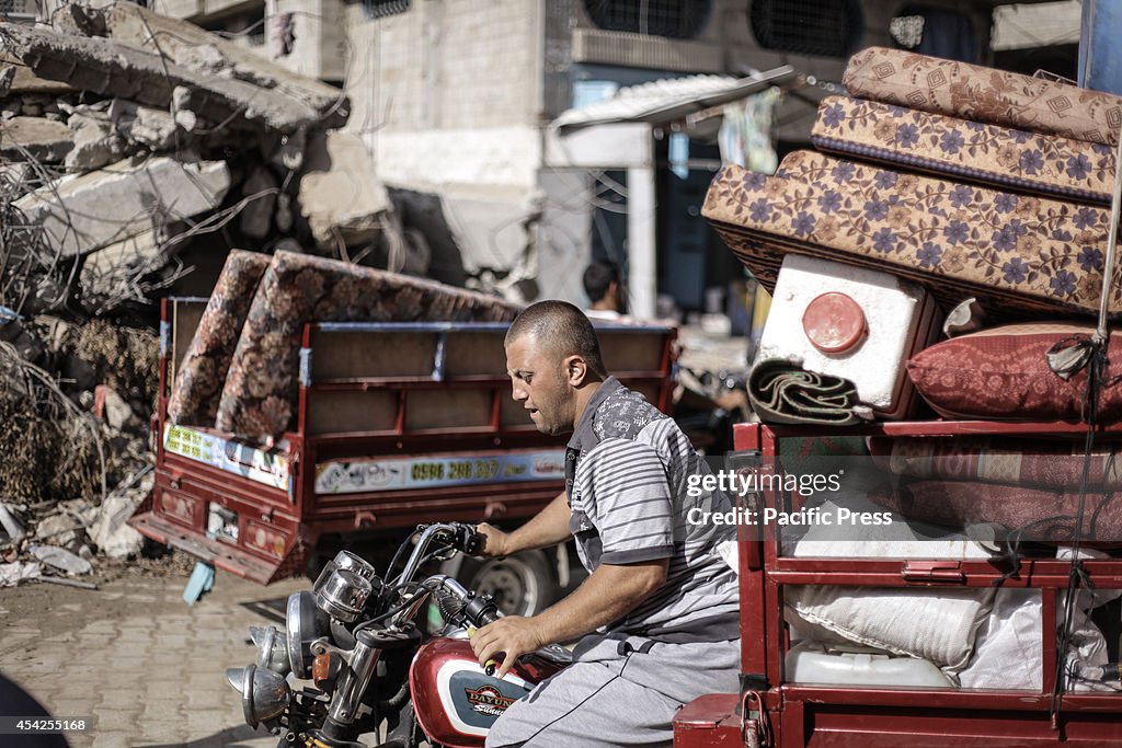 Local residents visit their destroyed homes to salvage their...