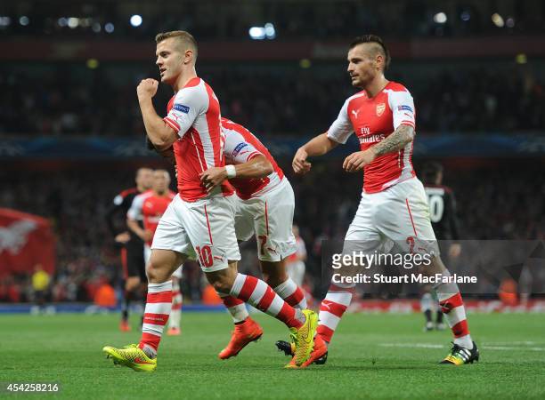 Jack Wilshere and Mathieu Debuchy celebrate the Arsenal goal, scored by Alexis Sanchez during the UEFA Champions League Qualifier 2nd leg match...