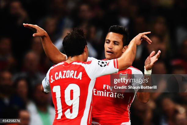 Alexis Sanchez of Arsenal celebrates with team mate Santi Cazorla of Arsenal after scoring during the UEFA Champions League Qualifier 2nd leg match...