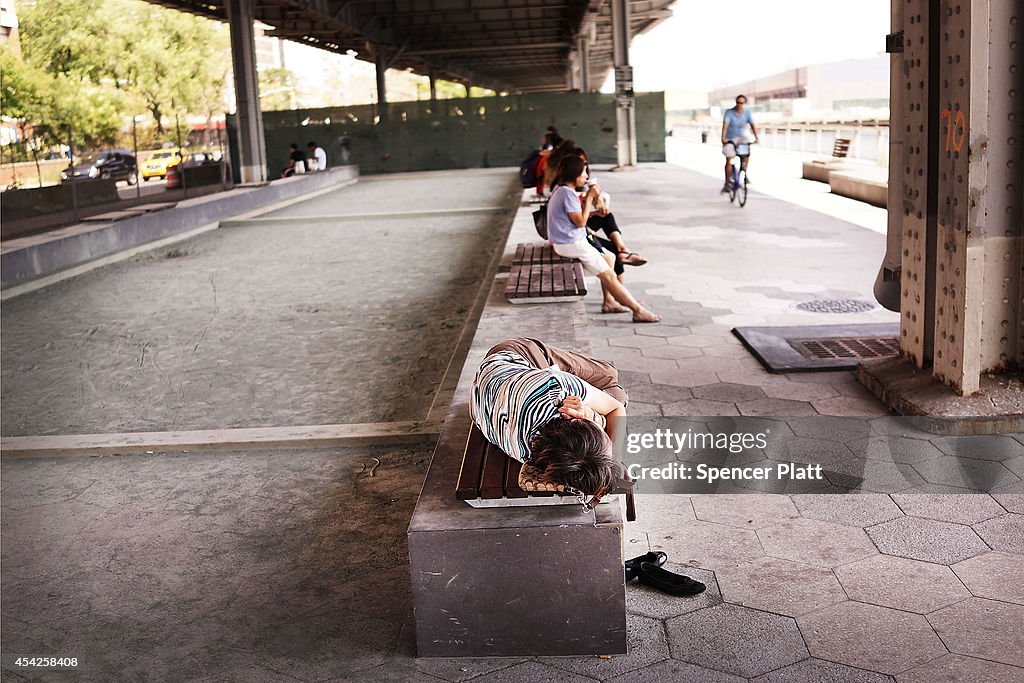 New Yorkers Cool Off Along Waterfront Park As Temperature Hit 90 Degrees