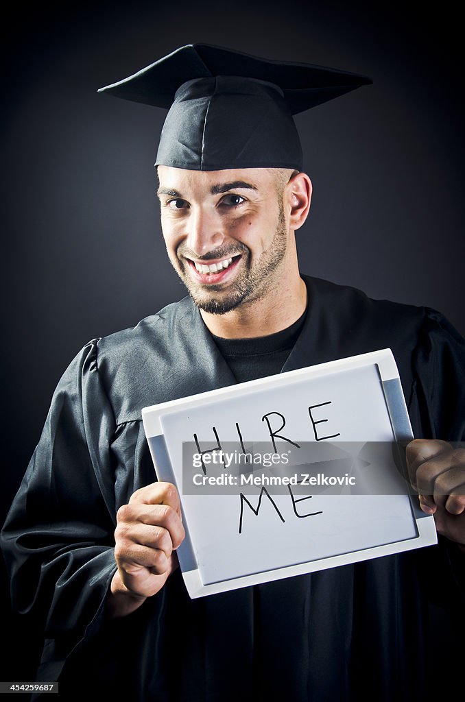 Smiling Graduate With Hire Me Sign