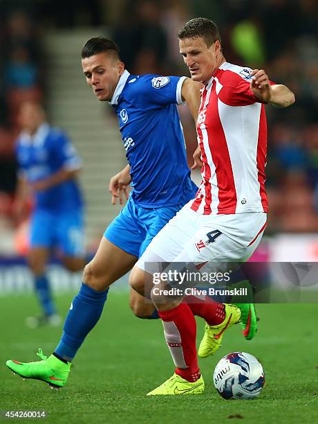 Robert Huth of Stoke City in action with Miles Storey of Portsmouth during the Capital One Cup Second Round match between Stoke City and Portsmouth...