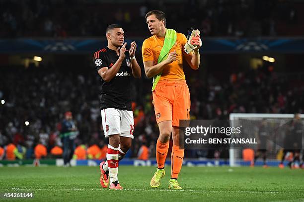 Arsenal's English midfielder Alex Oxlade-Chamberlain talks with Arsenal's Polish goalkeeper Wojciech Szczesny after the final whistle during the UEFA...