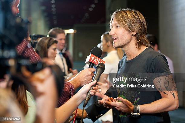 Keith Urban is interviewed by press as he arrives at the Ernest N. Morial Convention Center on August 27, 2014 in New Orleans, Louisiana.