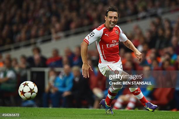 Arsenal's Spanish midfielder Santi Cazorla runs with the ball during the UEFA Champions League qualifying round play-off second-leg football match...