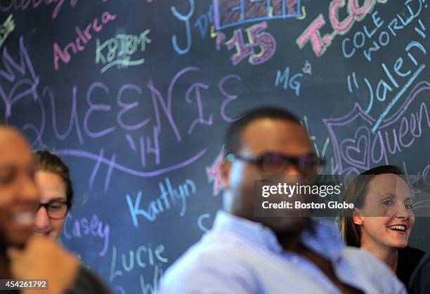 Anna Neumann tells the class she chose the name "DJ Illegal." She sits near a wall that was tagged by visitors to the archive. Professor Marcyliena...