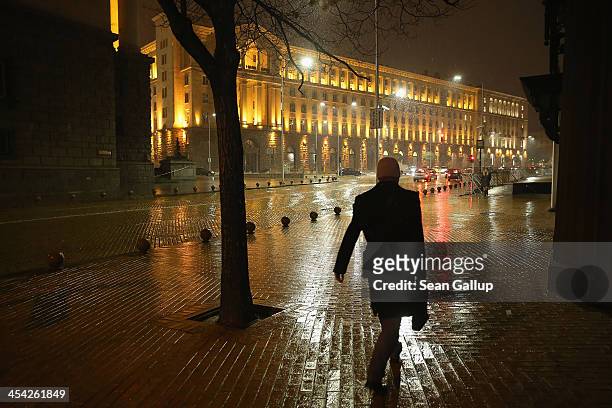 People walk near the Presidential Palace at night on December 6, 2013 in Sofia, Bulgaria. Restrictions on the freedom of Bulgarians and Romanians to...