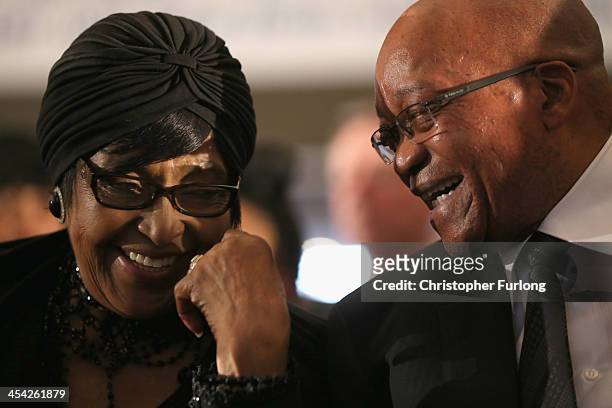 Winnie Madikizela-Mandela, ex-wife of former South Africa President Nelson Mandela and President Jacob Zuma smile and laugh as the watch children...