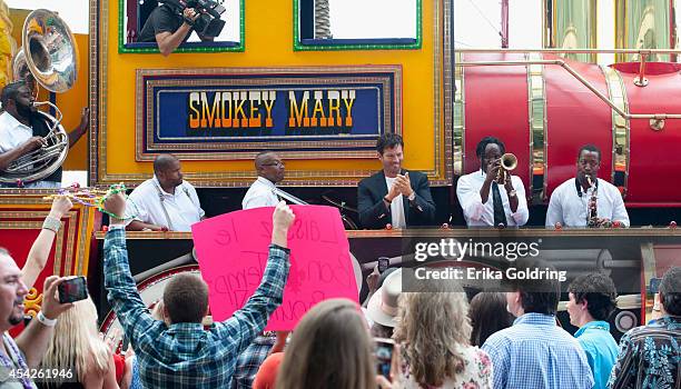 Harry Connick, Jr. And True Orleans Brass Band arrive at the Ernest N. Morial Convention Center on a Mardi Gras float on August 27, 2014 in New...