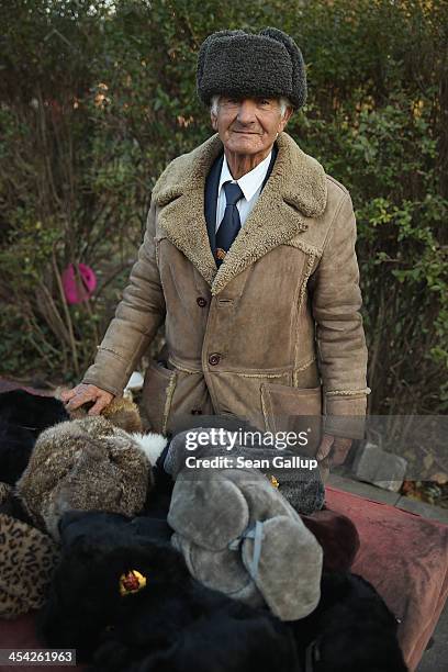 An elderly man selling fur hats at a flea market pauses for a photograph on December 5, 2013 in Sofia, Bulgaria. Restrictions on the freedom of...