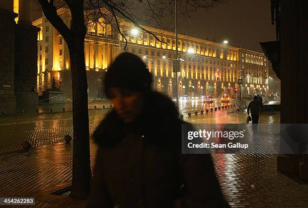 People walk near the Presidential Palace at night on December 6, 2013 in Sofia, Bulgaria. Restrictions on the freedom of Bulgarians and Romanians to...