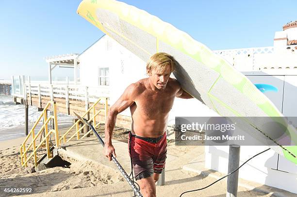 American big-wave surfer Laird Hamilton exits the beach during huge swells generated by hurricane Marie Reach along the the southern California...