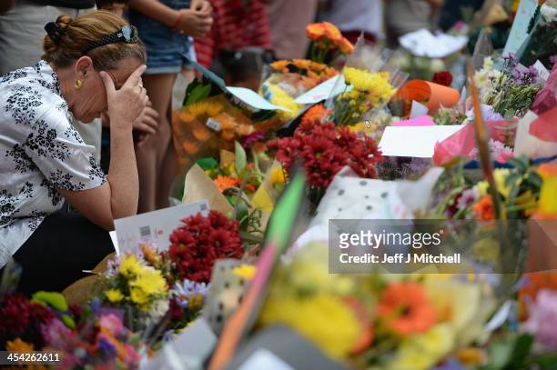 Members of the public gather at former presidents Nelson Mandelas Houghton home to pay their respects on December 8, 2013 in Johannesburg, South...