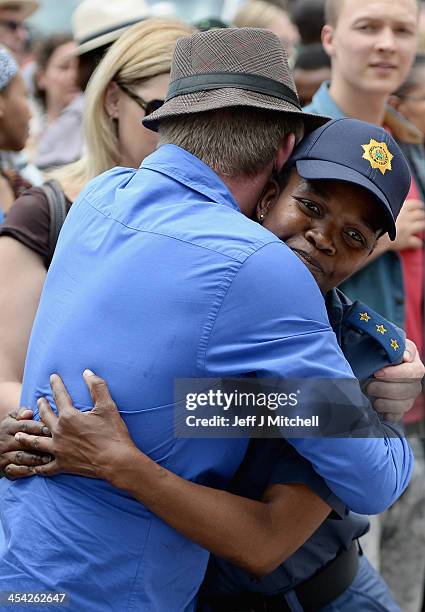 Members of the public gather at former presidents Nelson Mandelas Houghton home to pay their respects on December 8, 2013 in Johannesburg, South...