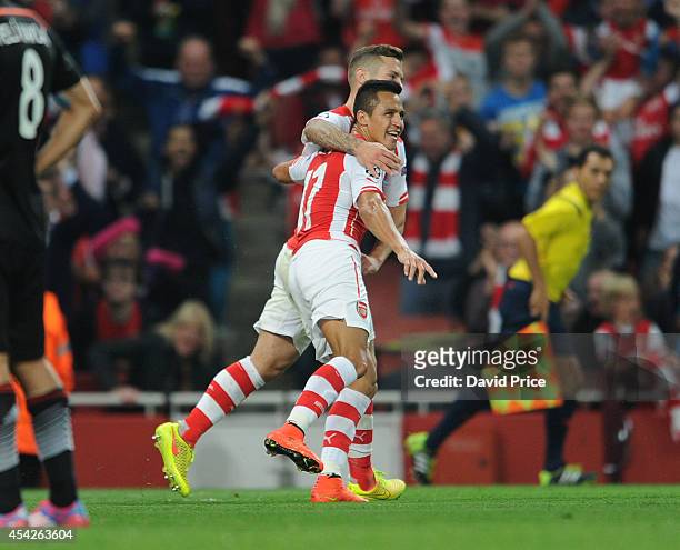 Alexis Sanchez celebrates scoring Arsenal's goal during the UEFA Champions League Qualifing match between Arsenal and Besiktas at Emirates Stadium on...