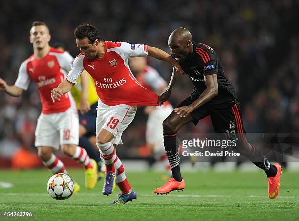 Santi Cazorla of Arsenal bursts past Atiba Hutchinson of Besiktas during the UEFA Champions League Qualifing match between Arsenal and Besiktas at...
