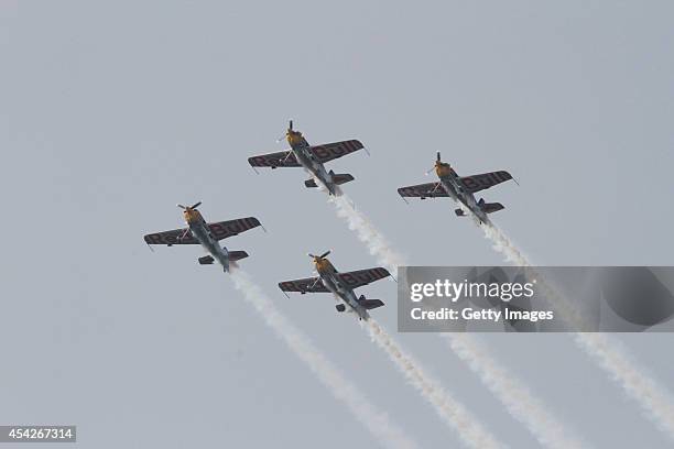 Pilots perform aerobatic flight during a contest on August 27, 2014 in Shenyang, Liaoning province of China. Three aerobatic flight teams...