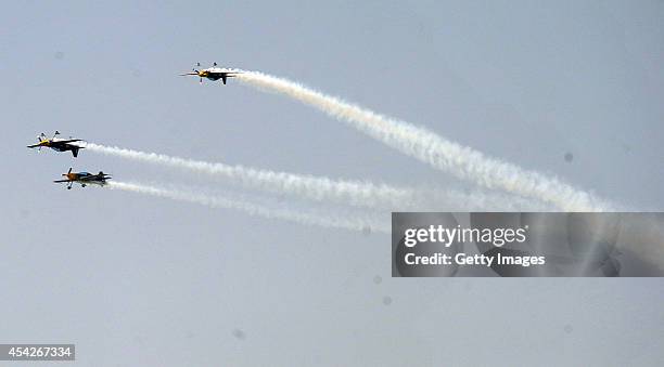 Pilots perform aerobatic flight during a contest on August 27, 2014 in Shenyang, Liaoning province of China. Three aerobatic flight teams...