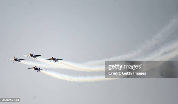 Pilots perform aerobatic flight during a contest on August 27, 2014 in Shenyang, Liaoning province of China. Three aerobatic flight teams...