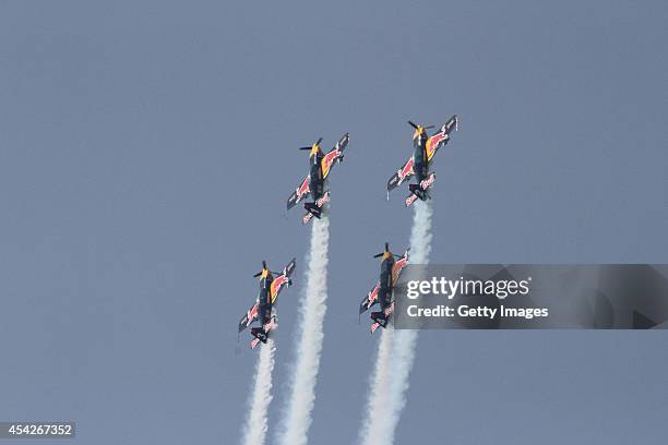 Pilots perform aerobatic flight during a contest on August 27, 2014 in Shenyang, Liaoning province of China. Three aerobatic flight teams...
