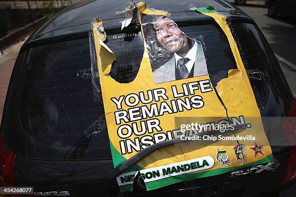 Torn poster is taped ot the back of a car outside the Standard Bank Arena ahead of an African National Congress prayer meeting during a national day...