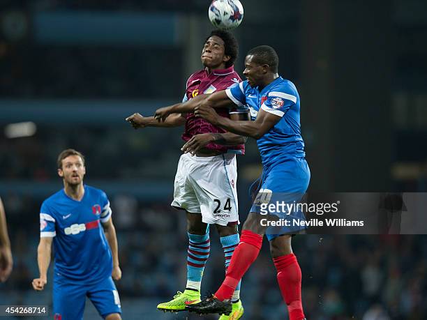 Carlos Sanchez of Aston Villa are challenged by Marvin Bartley of Leyton Orient during the Capital One Cup second round match between Aston Villa and...
