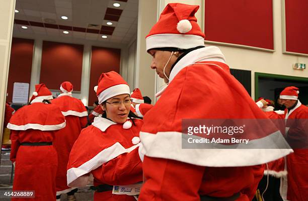 Participants dress up as Santa Claus prior to competing in the 5th annual Michendorf Santa Run on December 8, 2013 in Michendorf, Germany. Over 900...